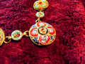 Vintage Italian micro mosaic necklace laid flat in heart shape on red velvet