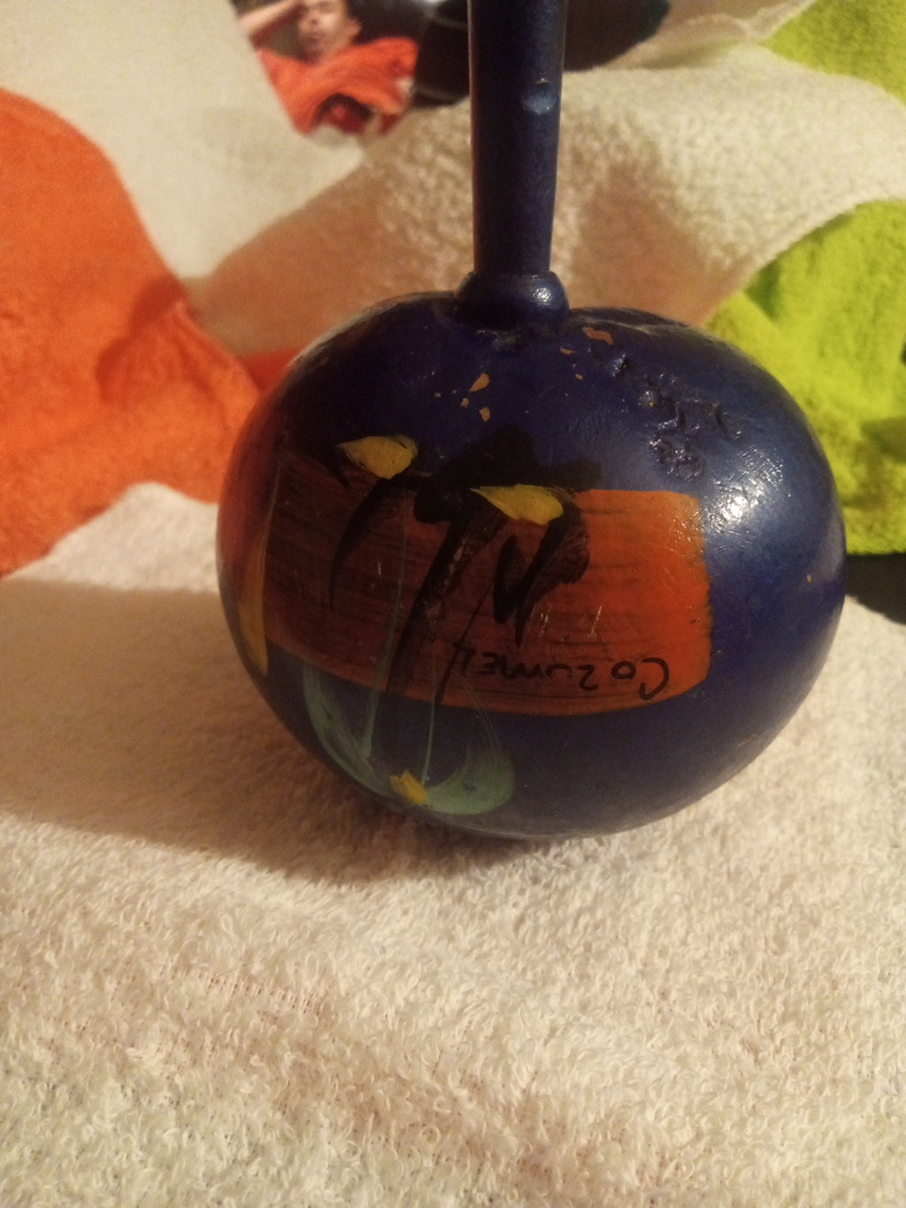 Reverse view of hand-painted blue maraca