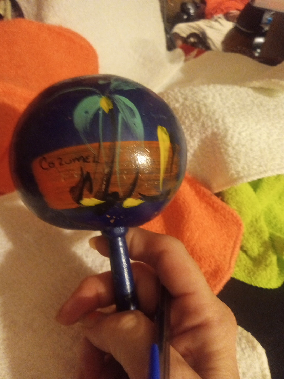 Hand-painted blue maraca with colorful tropical scene